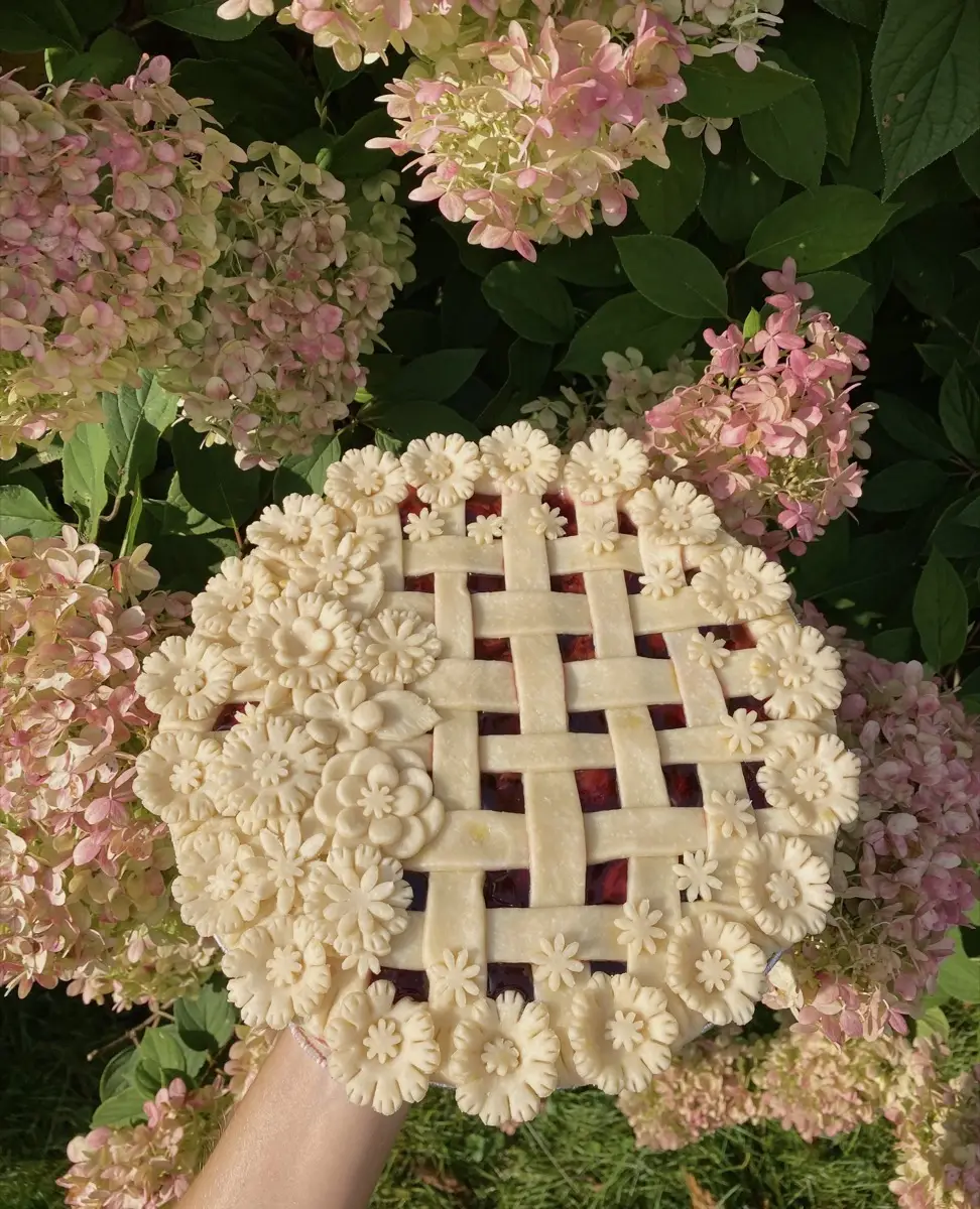 A Birdie’s floral lattice pie held beside pink hydrangeas