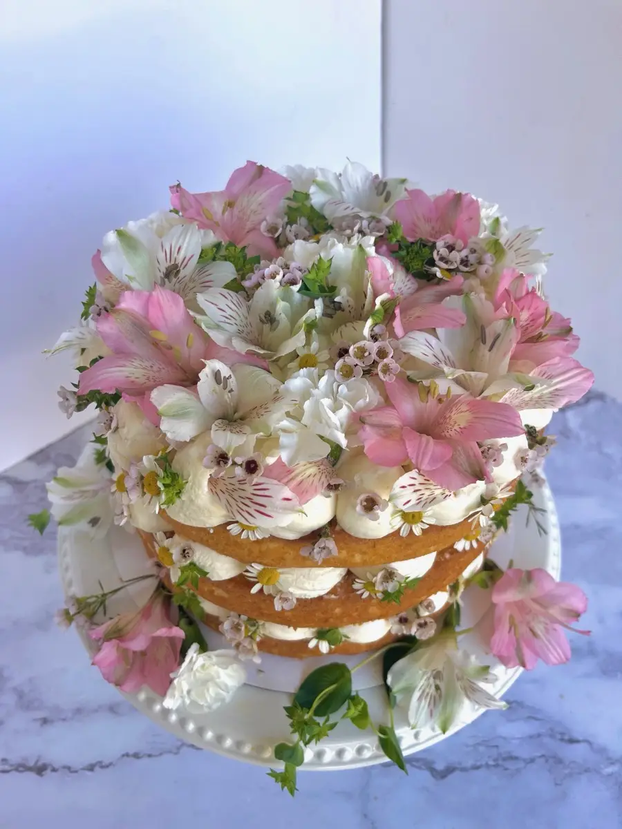 Layer cake with pink alstroemeria and wax flowers