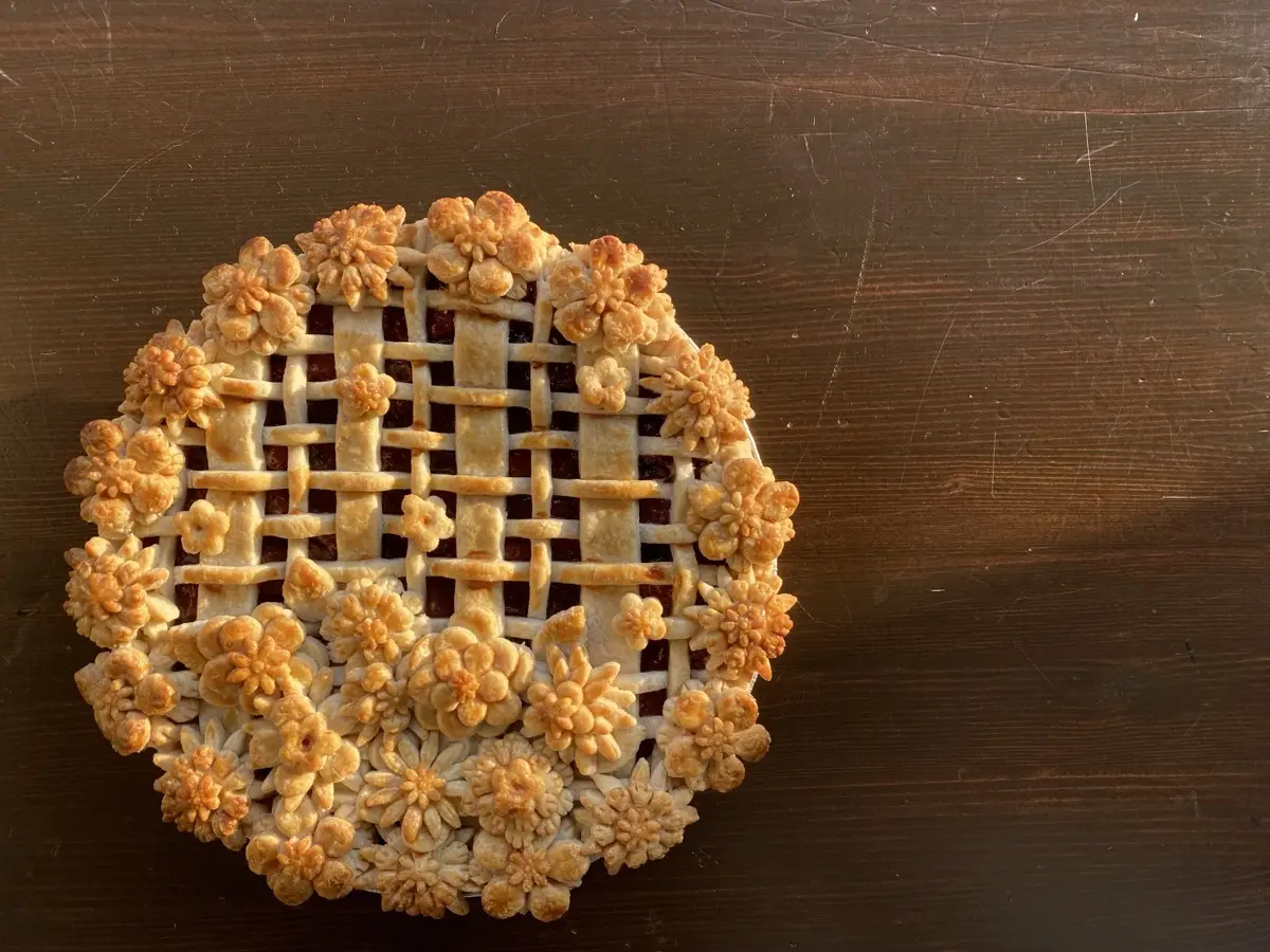 Golden floral lattice pie on a wooden table